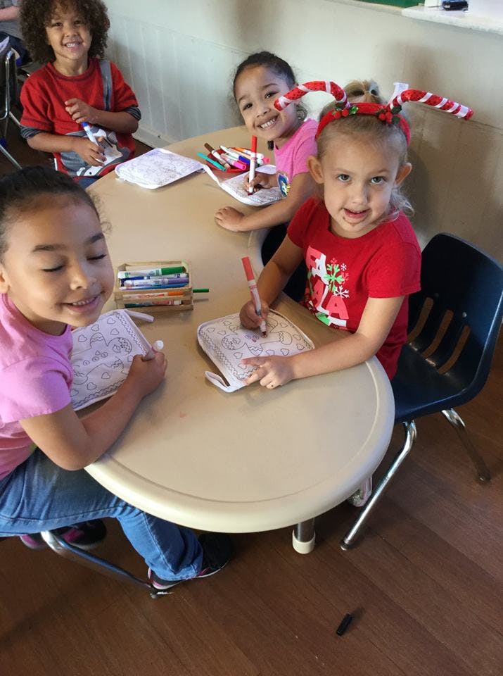 Children coloring at a table