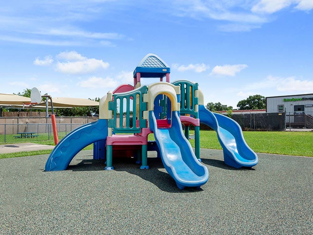 A colorful playground with multiple slides and climbing structures