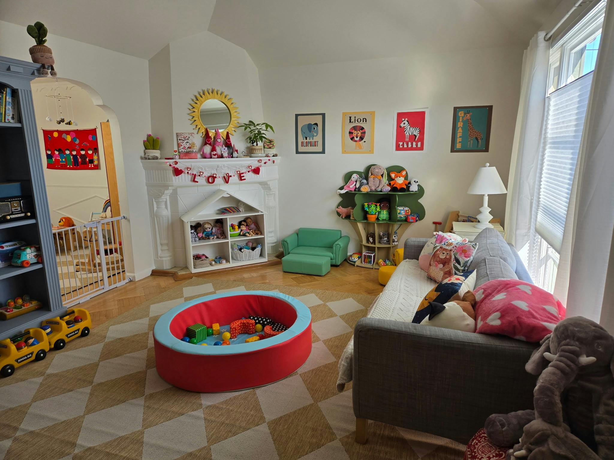 Playroom with a ball pit, sofa, and toy storage