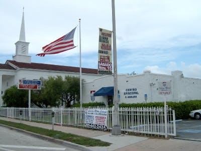 Church building with steeple and American flag flying