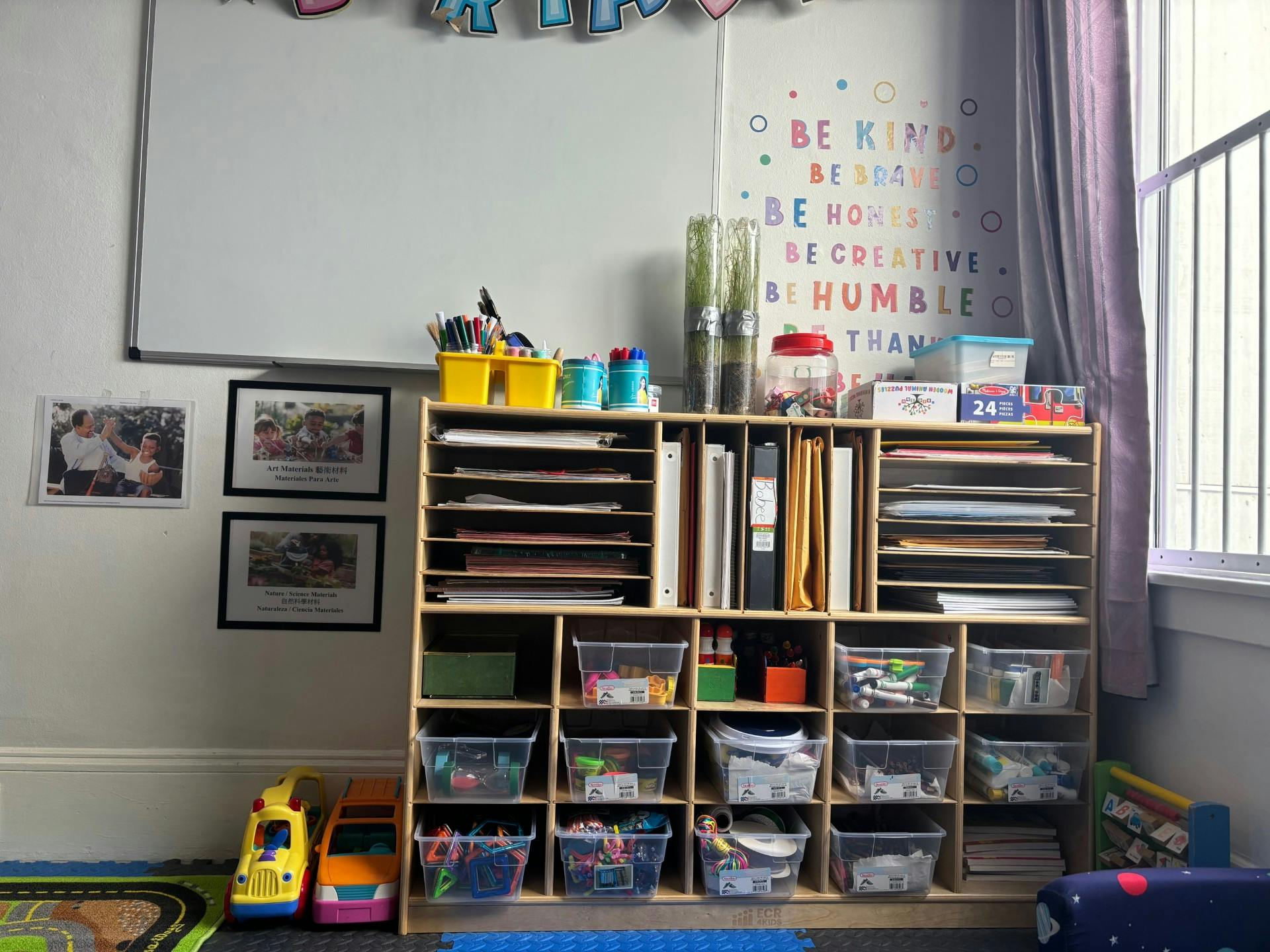 Storage shelves with bins, papers, and supplies in a room