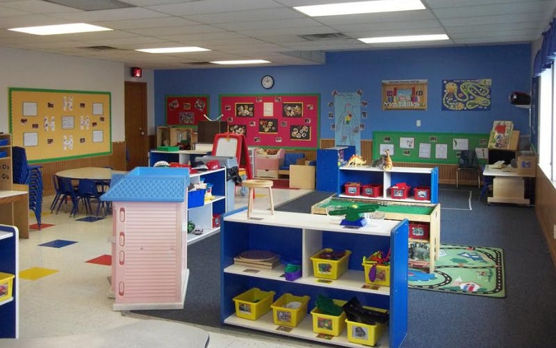 Colorful classroom with various learning stations and play areas