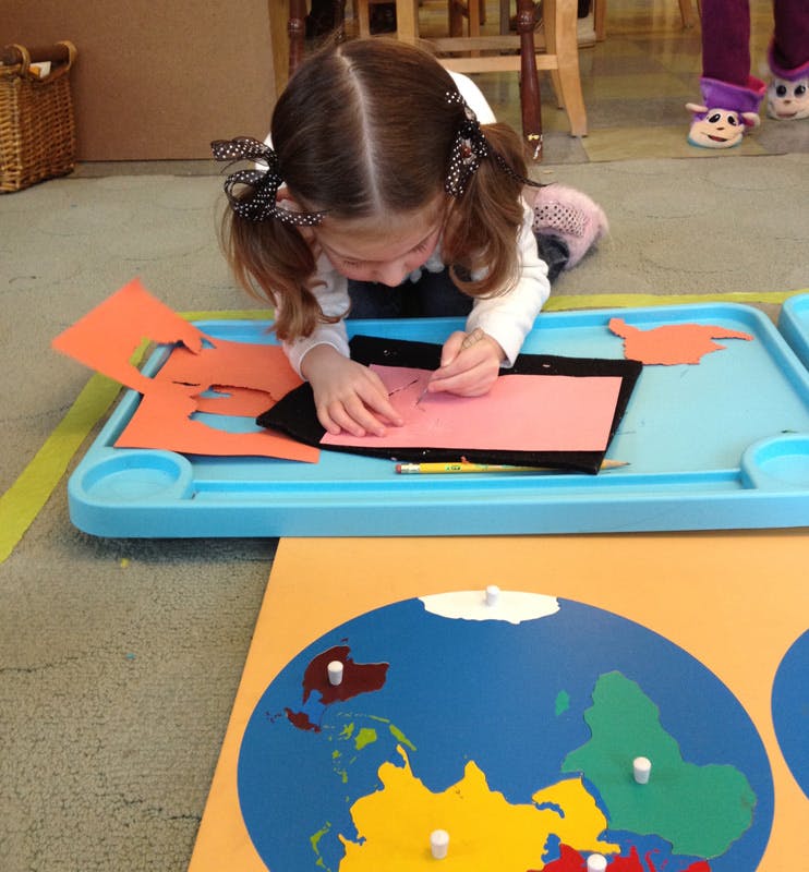 Child working on a craft with paper and pencil