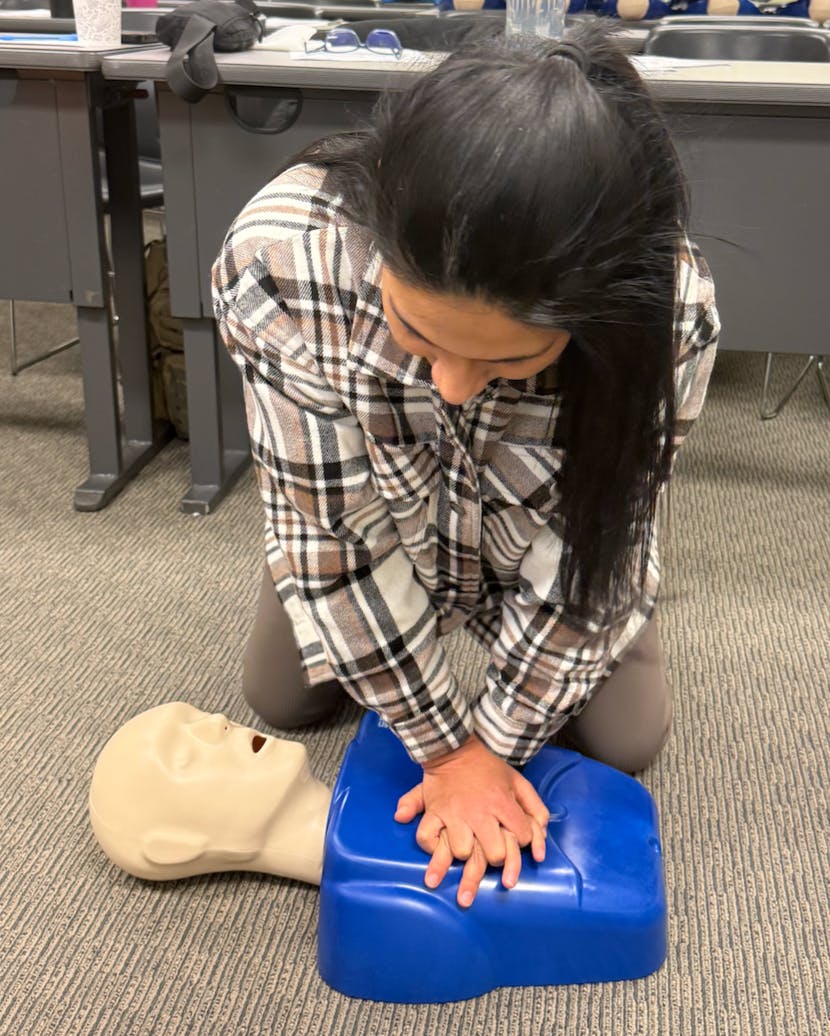 Person performing CPR on a mannequin