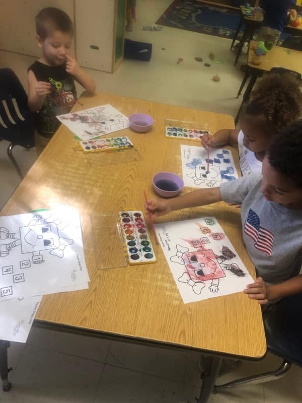 Children painting at a table