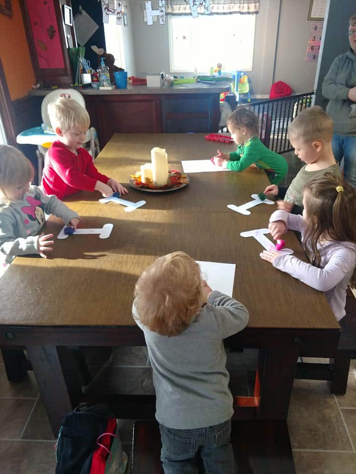 Children sitting around a table doing crafts