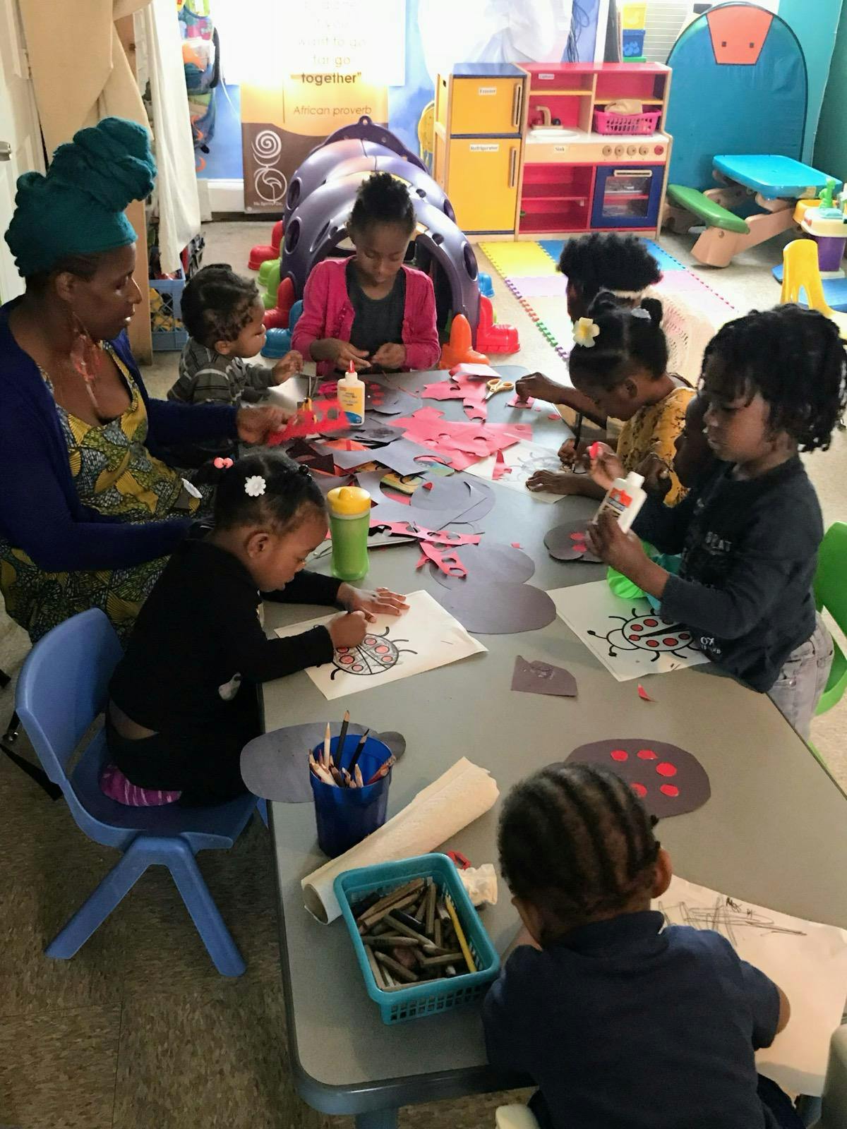 Adult and children doing crafts at a table