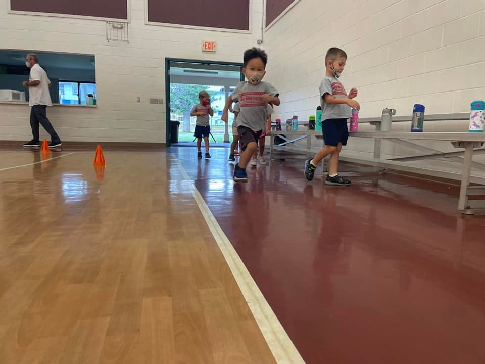 Children running in an indoor space