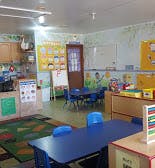Empty classroom with small tables and chairs