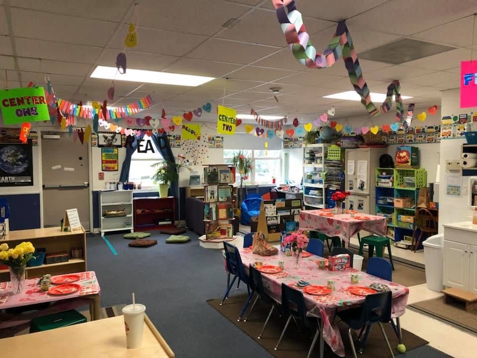 Classroom decorated with colorful banners and tables set for children