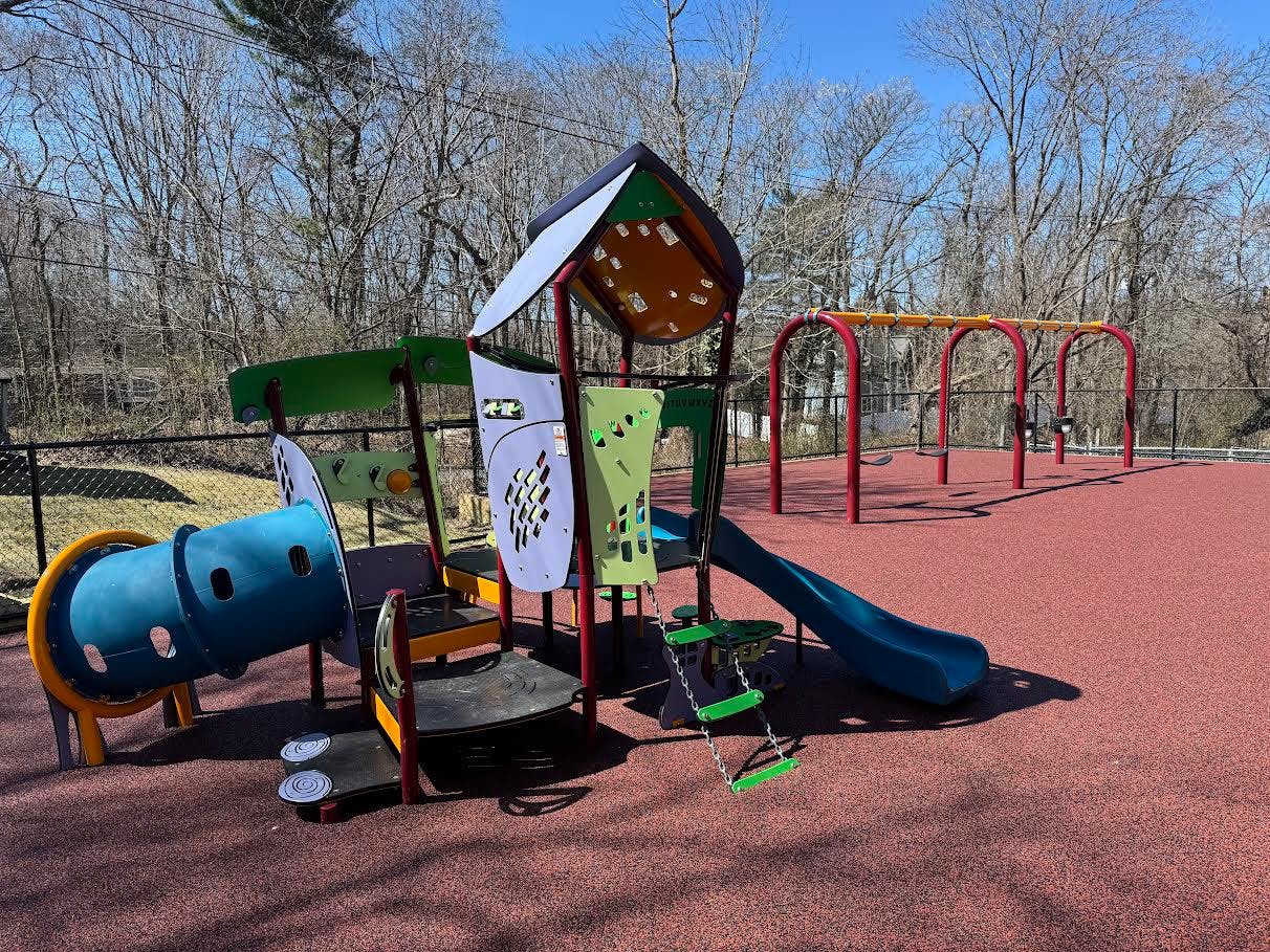 Playground with slides, tunnels, and swings