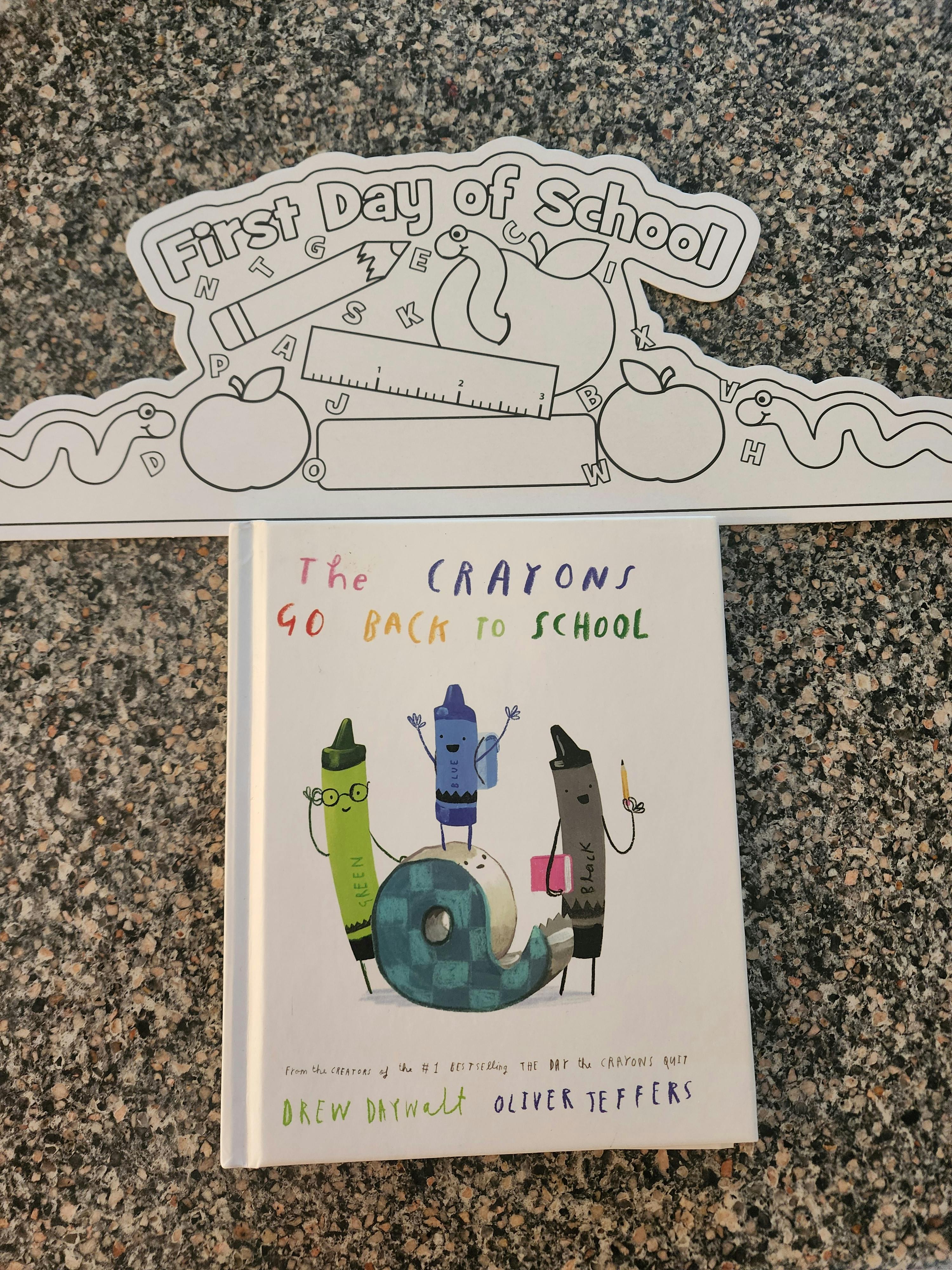 The Crayons Go Back to School book next to a First Day of School coloring page