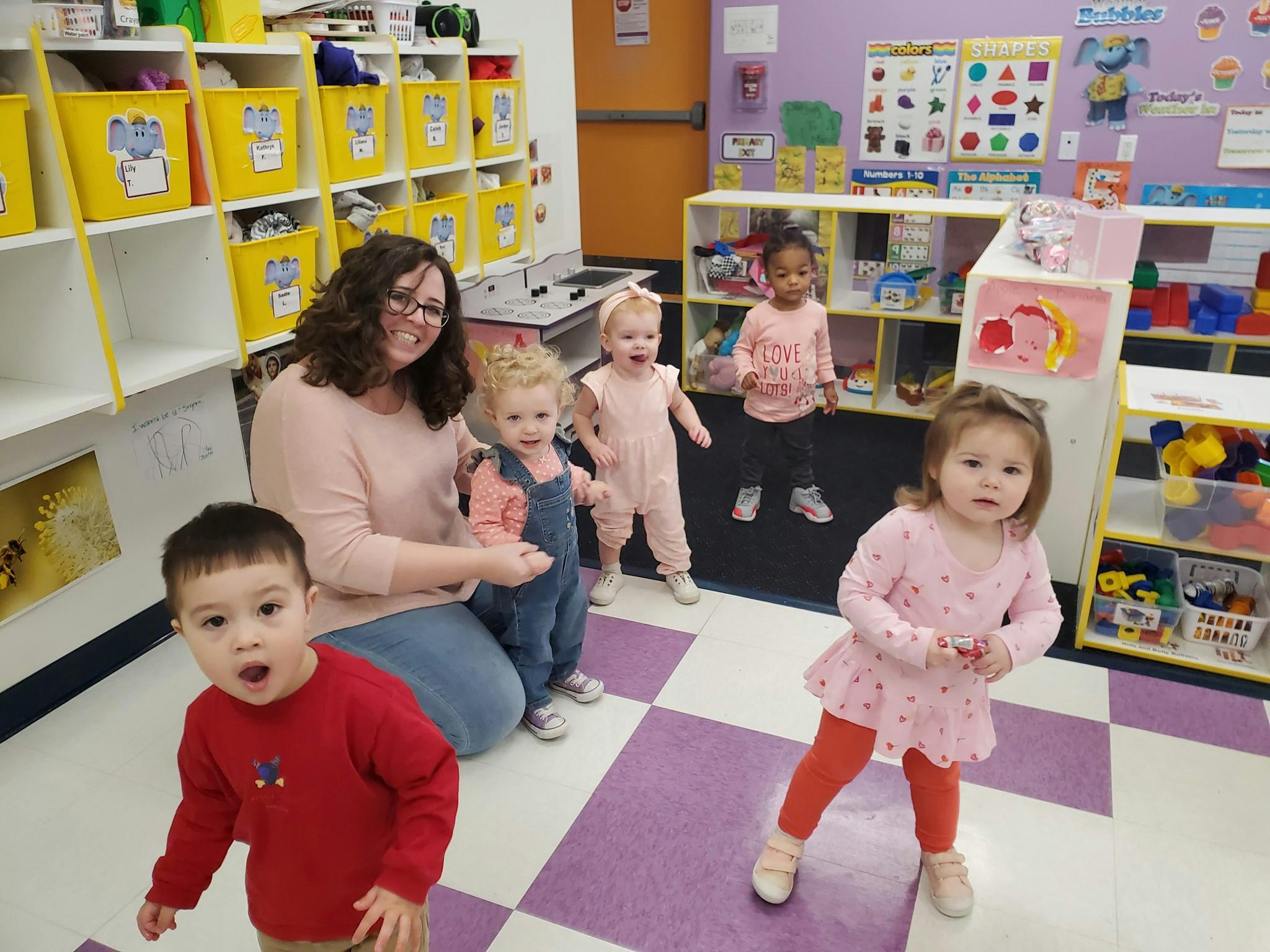 Adult and multiple children in a classroom