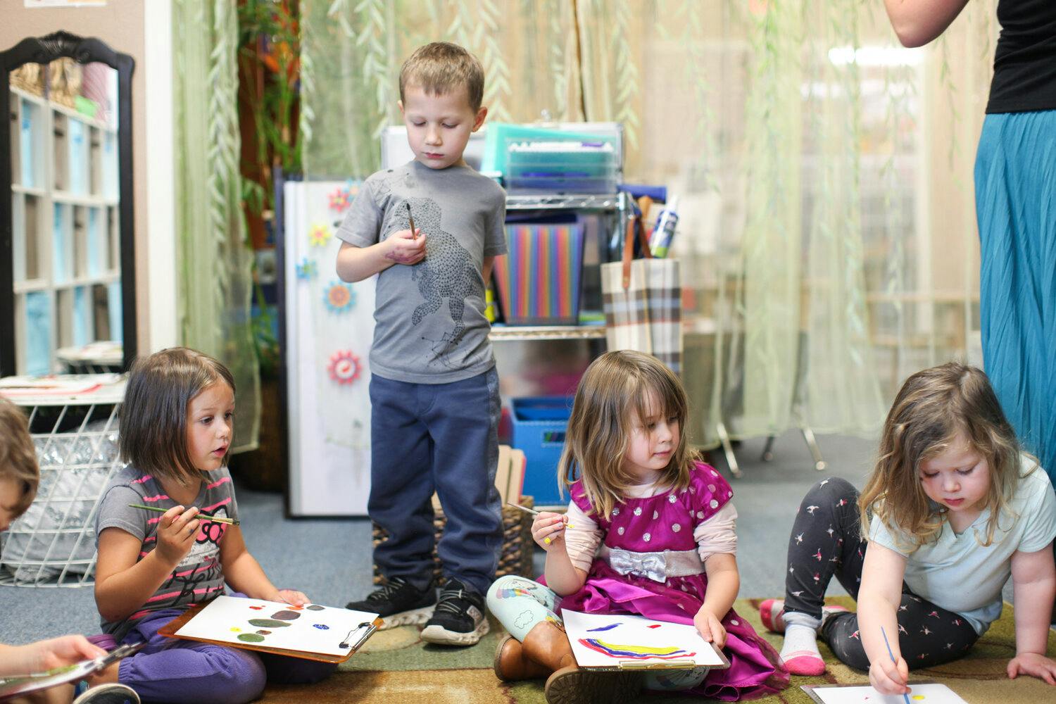 Children drawing and coloring on the floor