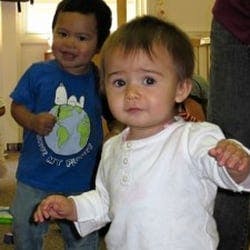 Two children standing indoors