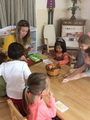 Adult and children sitting around a table
