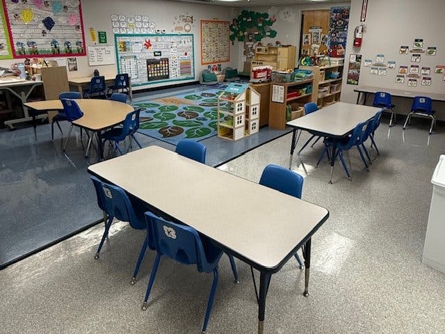 empty classroom with tables and chairs