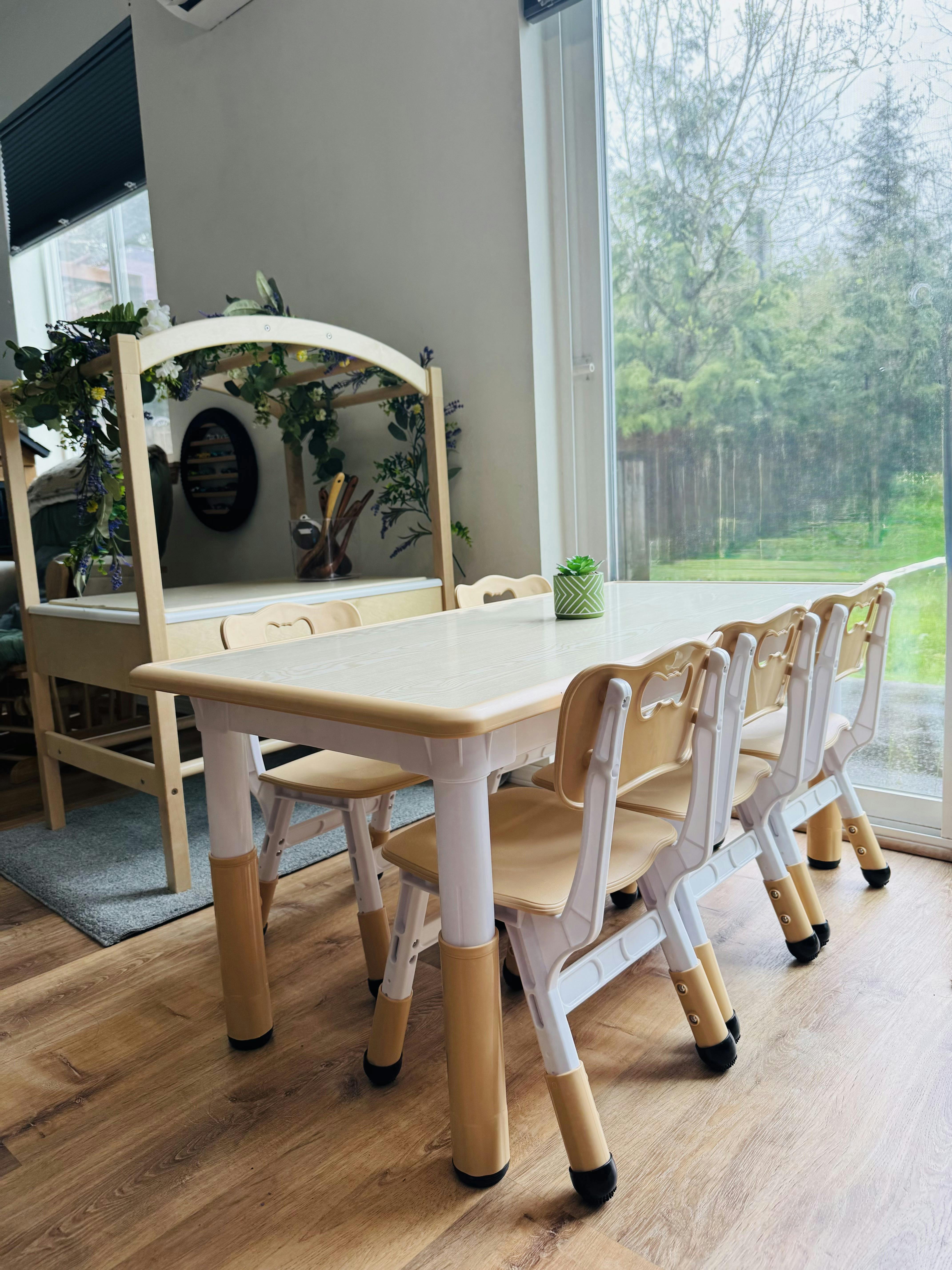 Children's table and chairs in a room with a large window