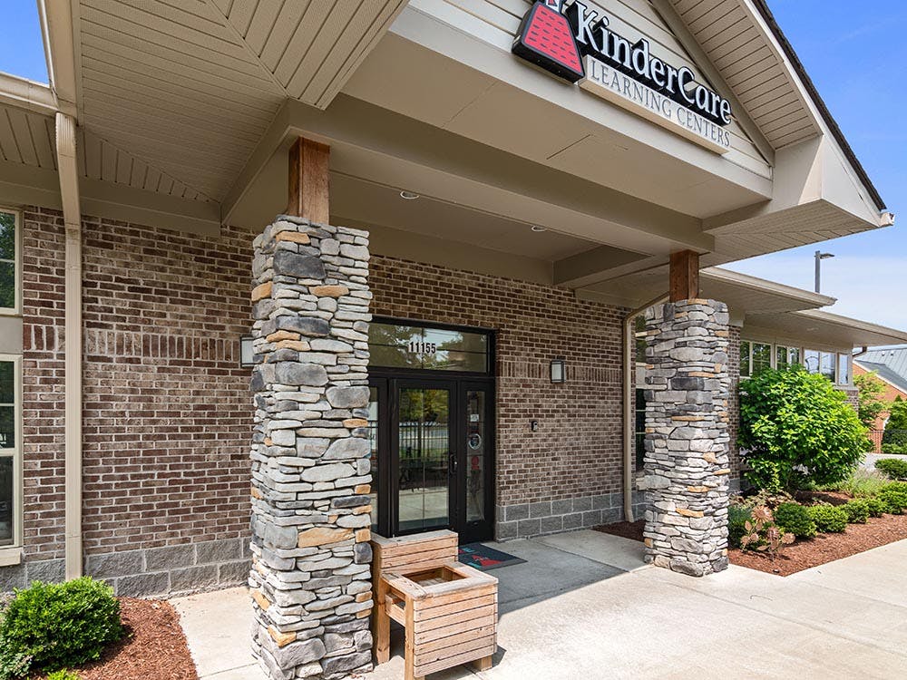 Entrance to a KinderCare Learning Centers building with stone and brick facade