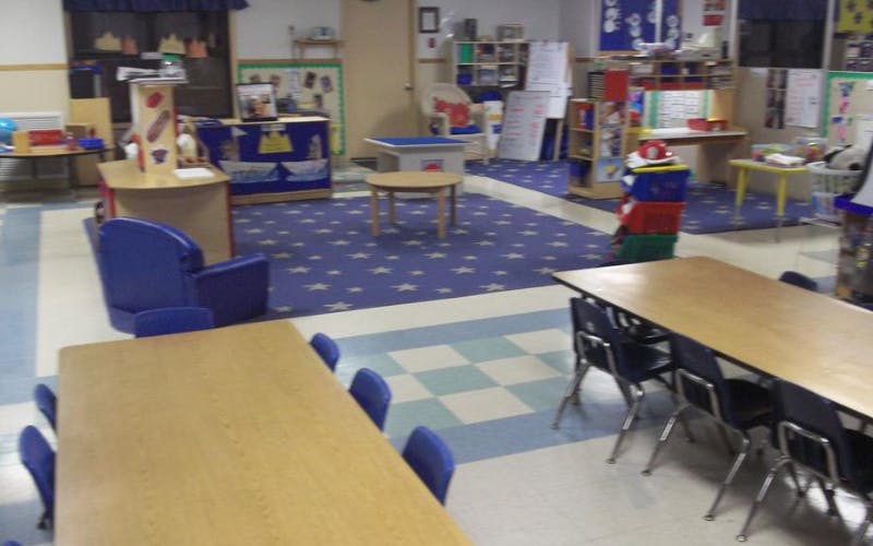 Classroom with tables, chairs, and play areas