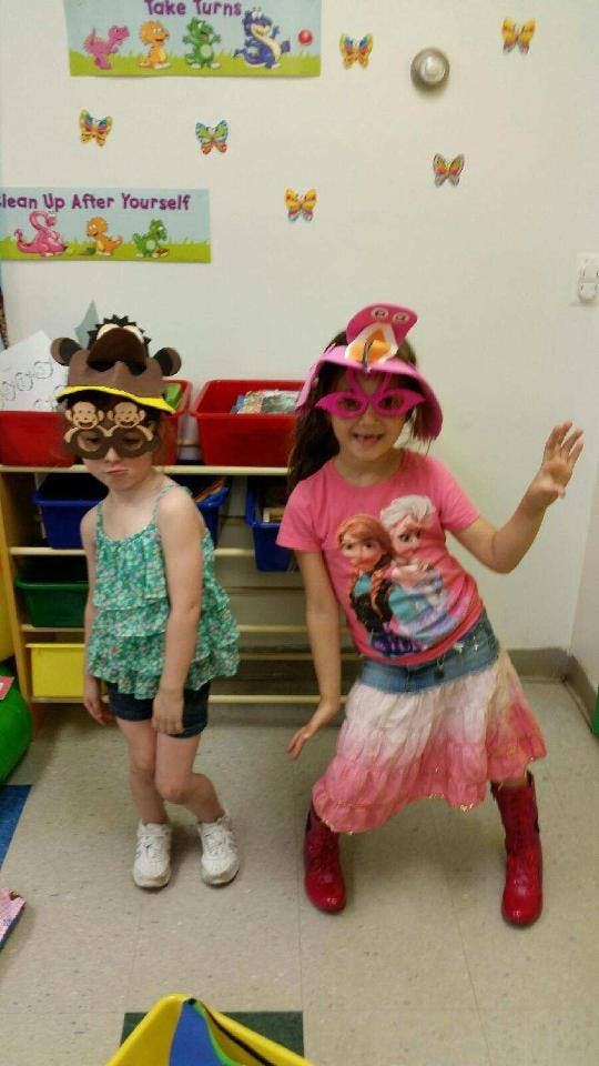Two children in costume hats and glasses