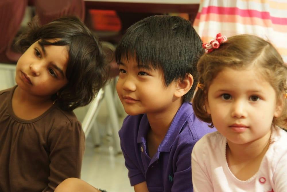 Three children looking in different directions