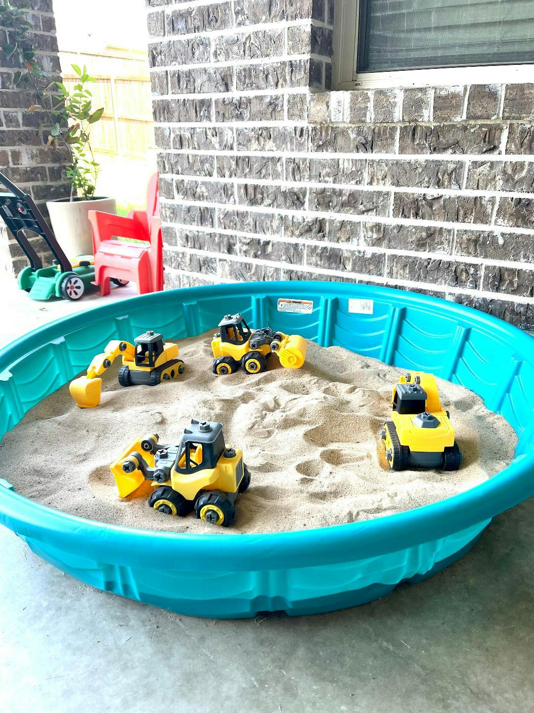 Toy construction vehicles in a sandbox