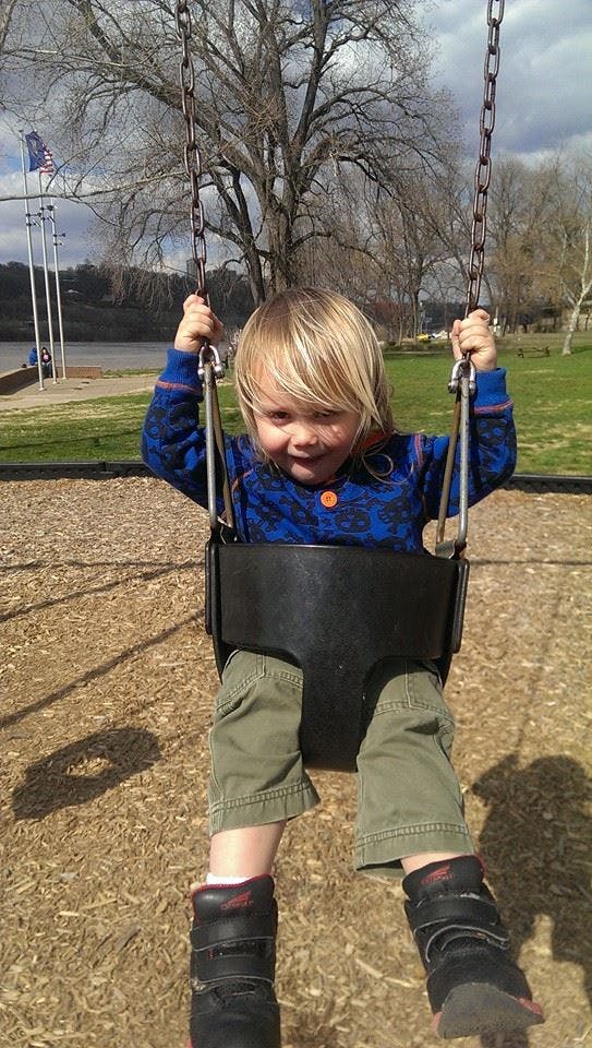 Child on a swing at a playground