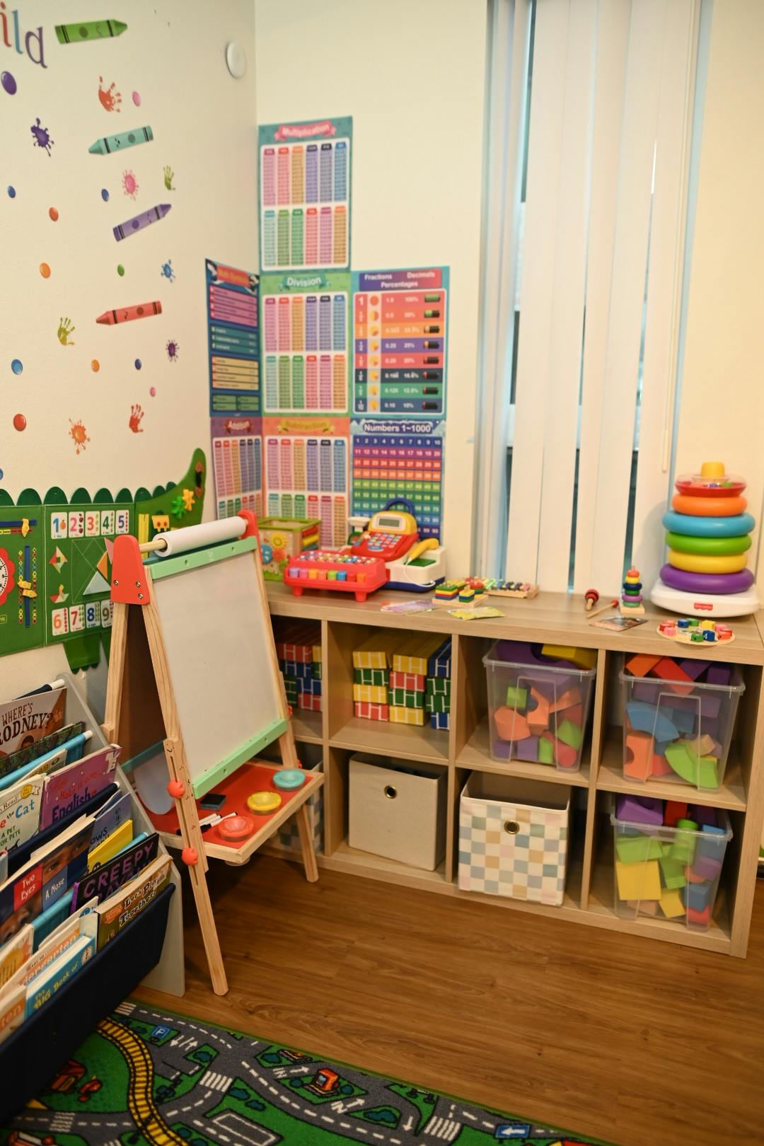 Child's playroom with shelves of toys, books, and an easel