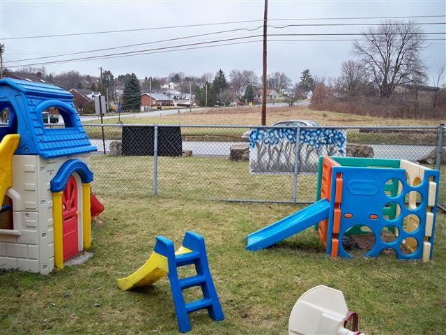 Playground with a playhouse, slide, and climbing structure