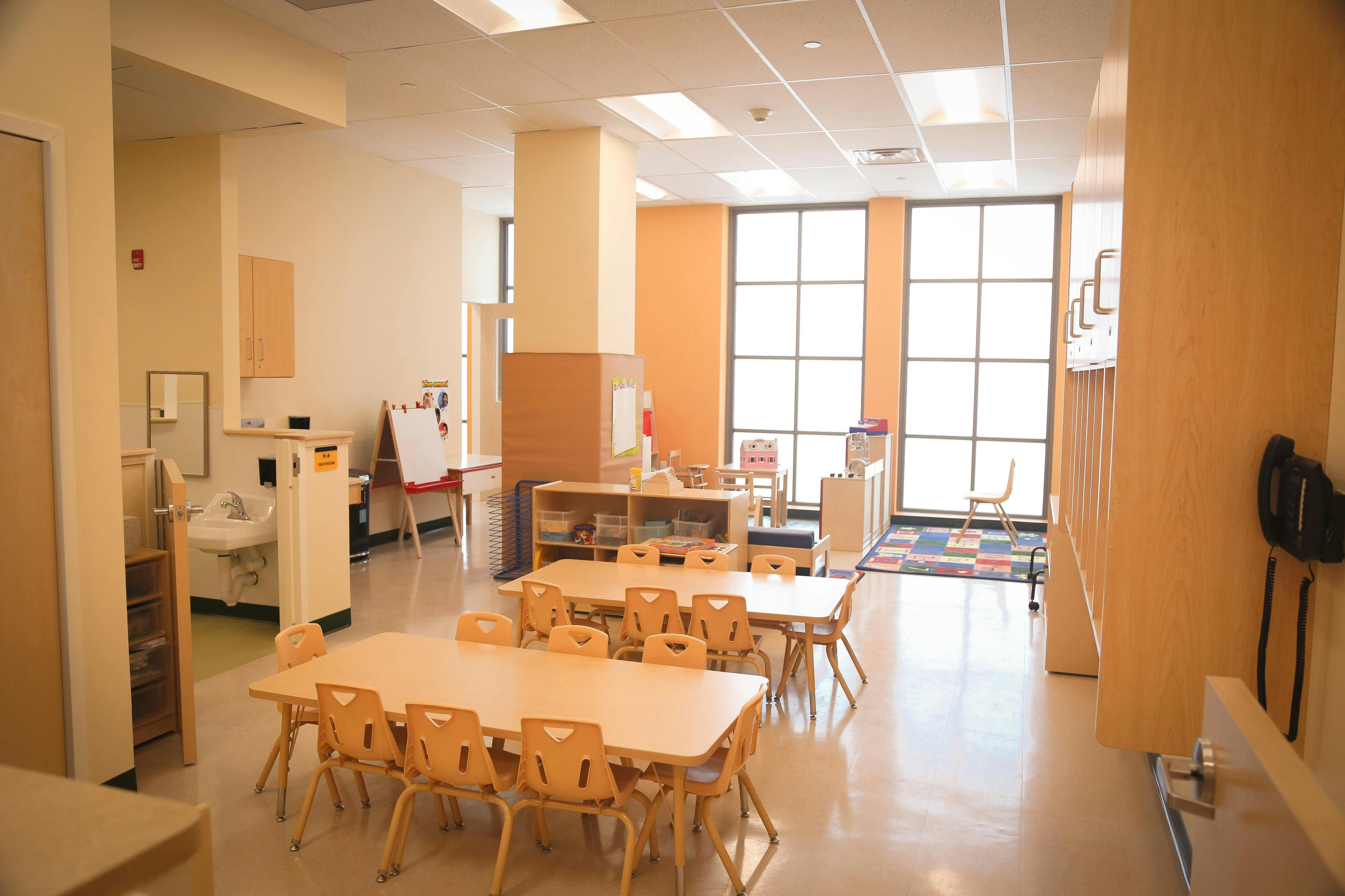 Empty classroom with small tables and chairs