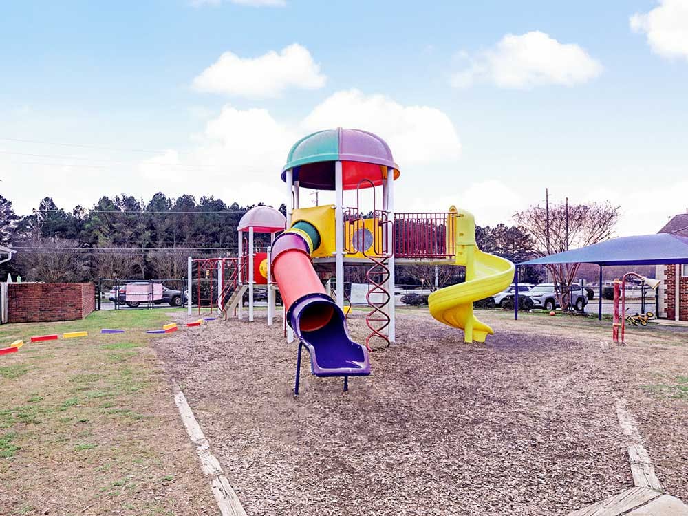 Colorful playground structure with multiple slides and climbing areas