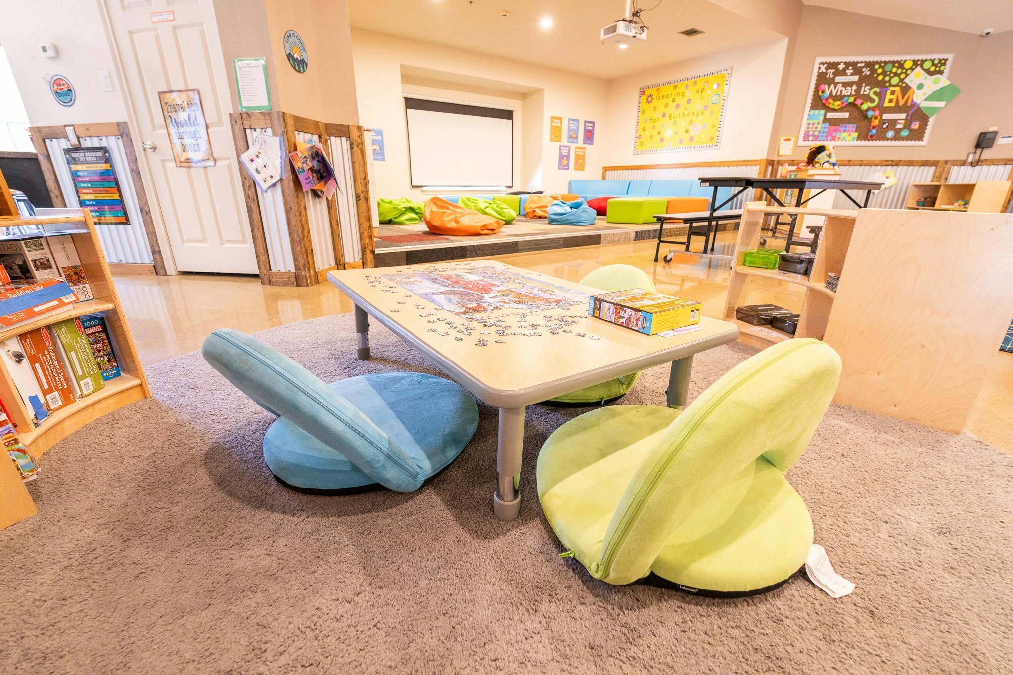 Low puzzle table with floor chairs in a classroom