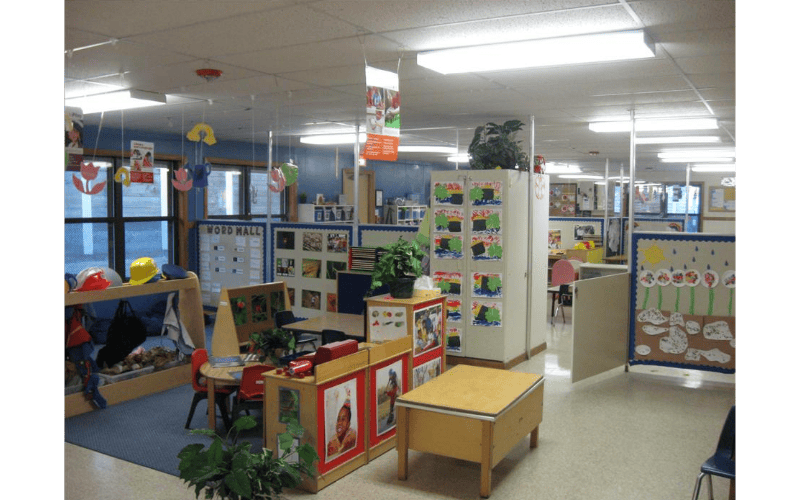 Classroom with child-sized furniture and artwork on walls