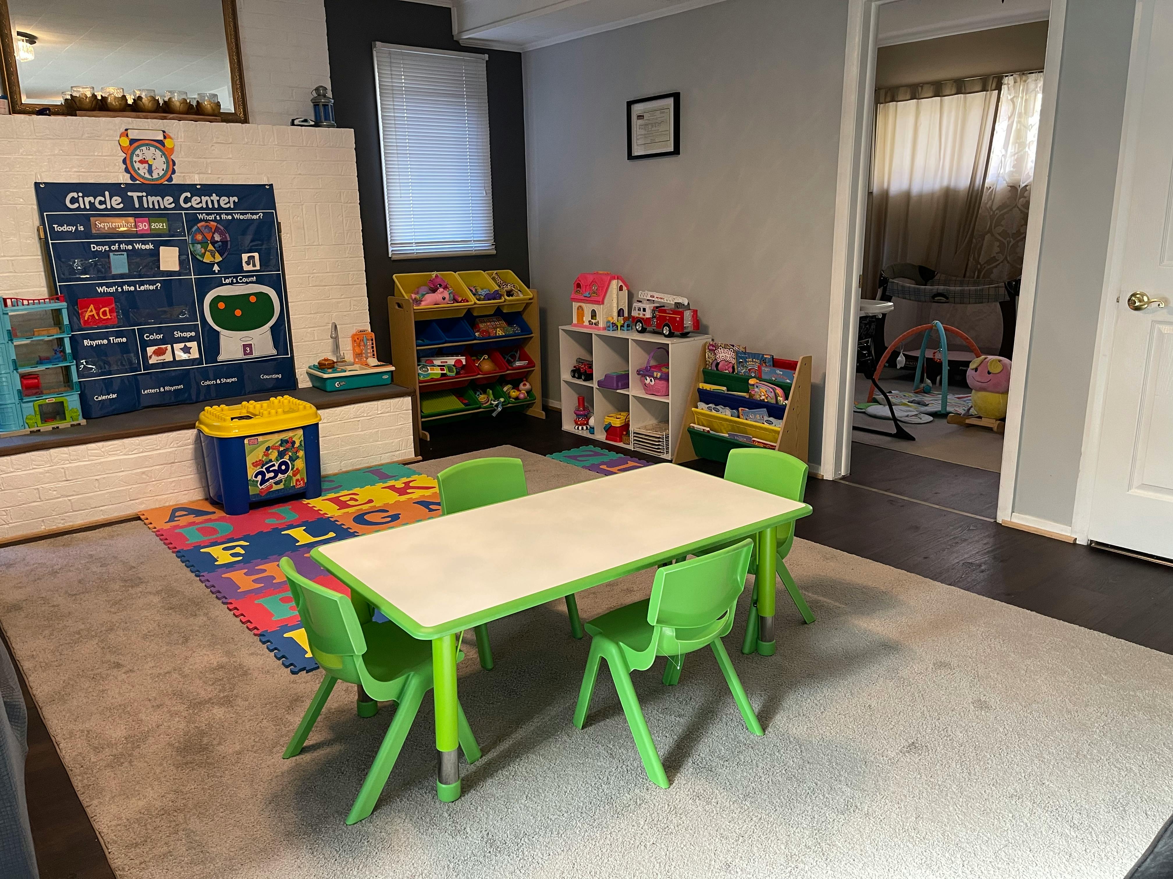 Classroom with a small table and chairs, toys, and a "Circle Time Center" chart