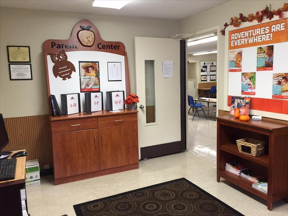 Parent Center display with folders, owl, clock, and "ADVENTURES ARE EVERYWHERE!" sign