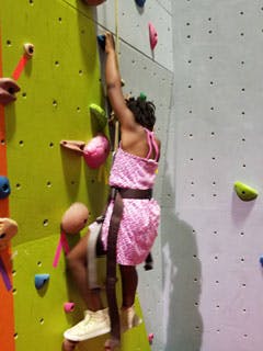 Child climbing an indoor rock wall
