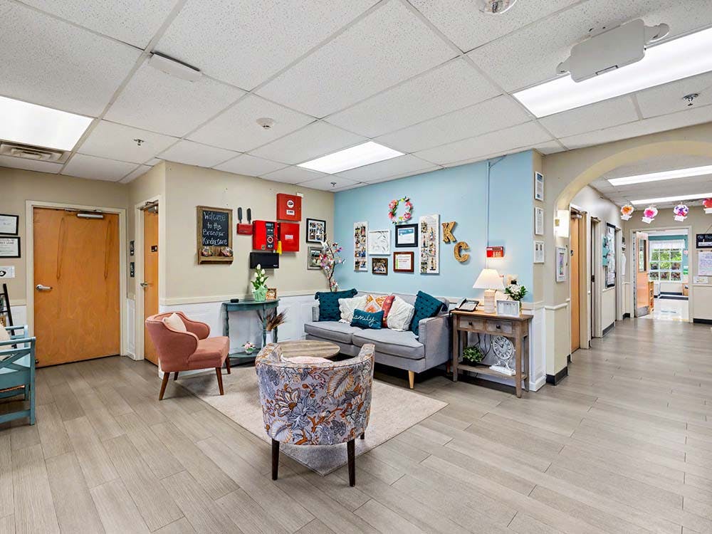 Lobby area with a sofa, two armchairs, and various wall decorations