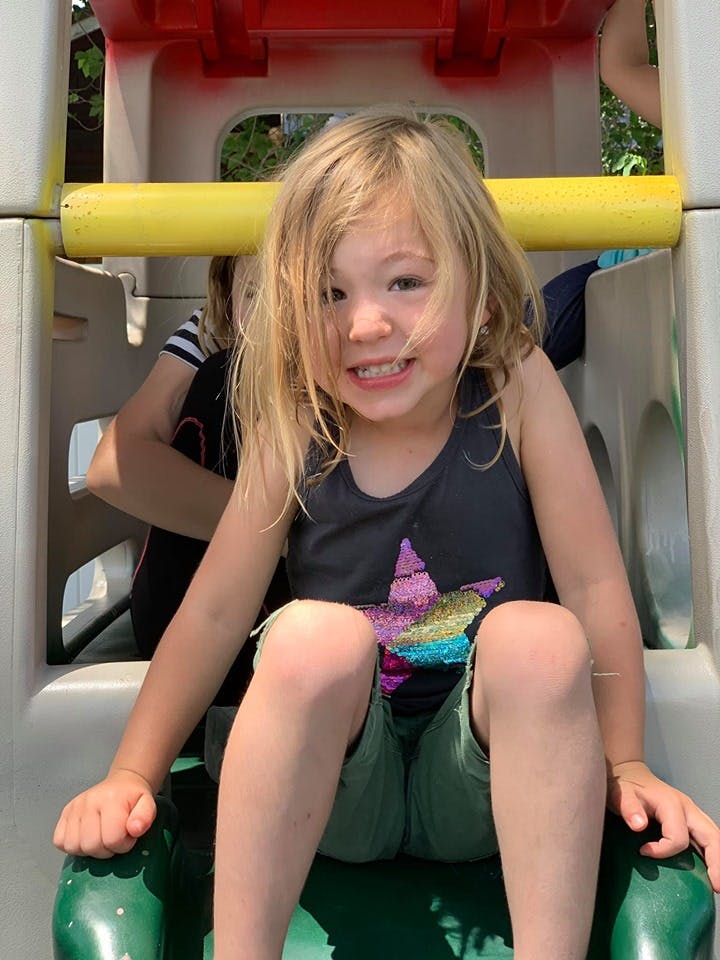 Child sitting on a playground slide