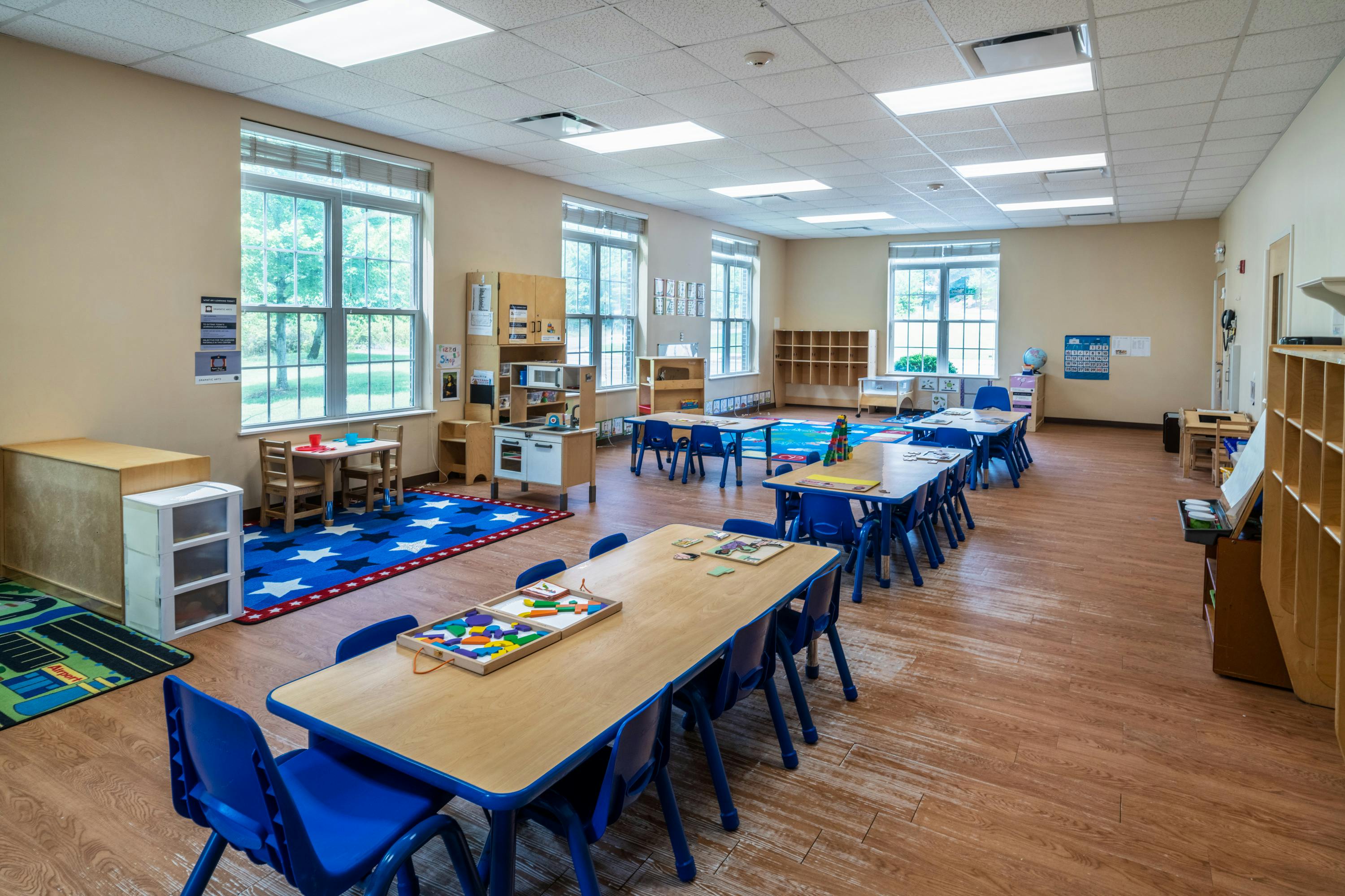 Empty classroom with small tables and chairs