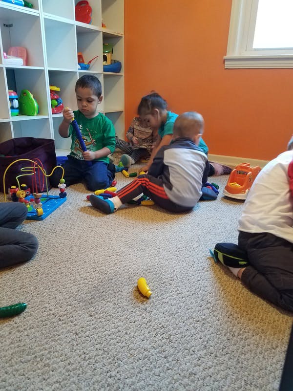 Children playing with toys on a carpeted floor
