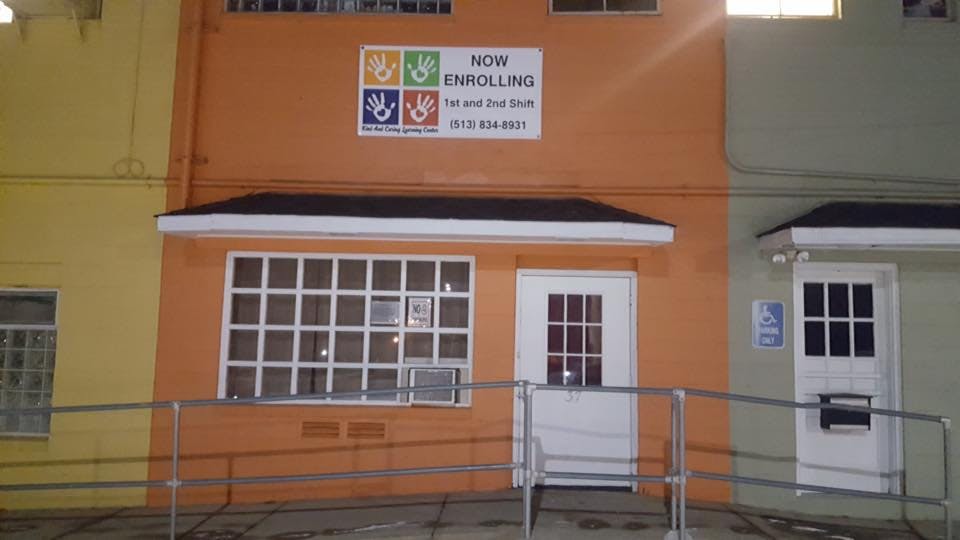 Building exterior with a sign that says "Now Enrolling"