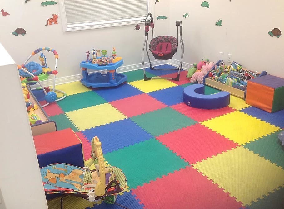 Playroom with colorful interlocking floor mats and various child toys