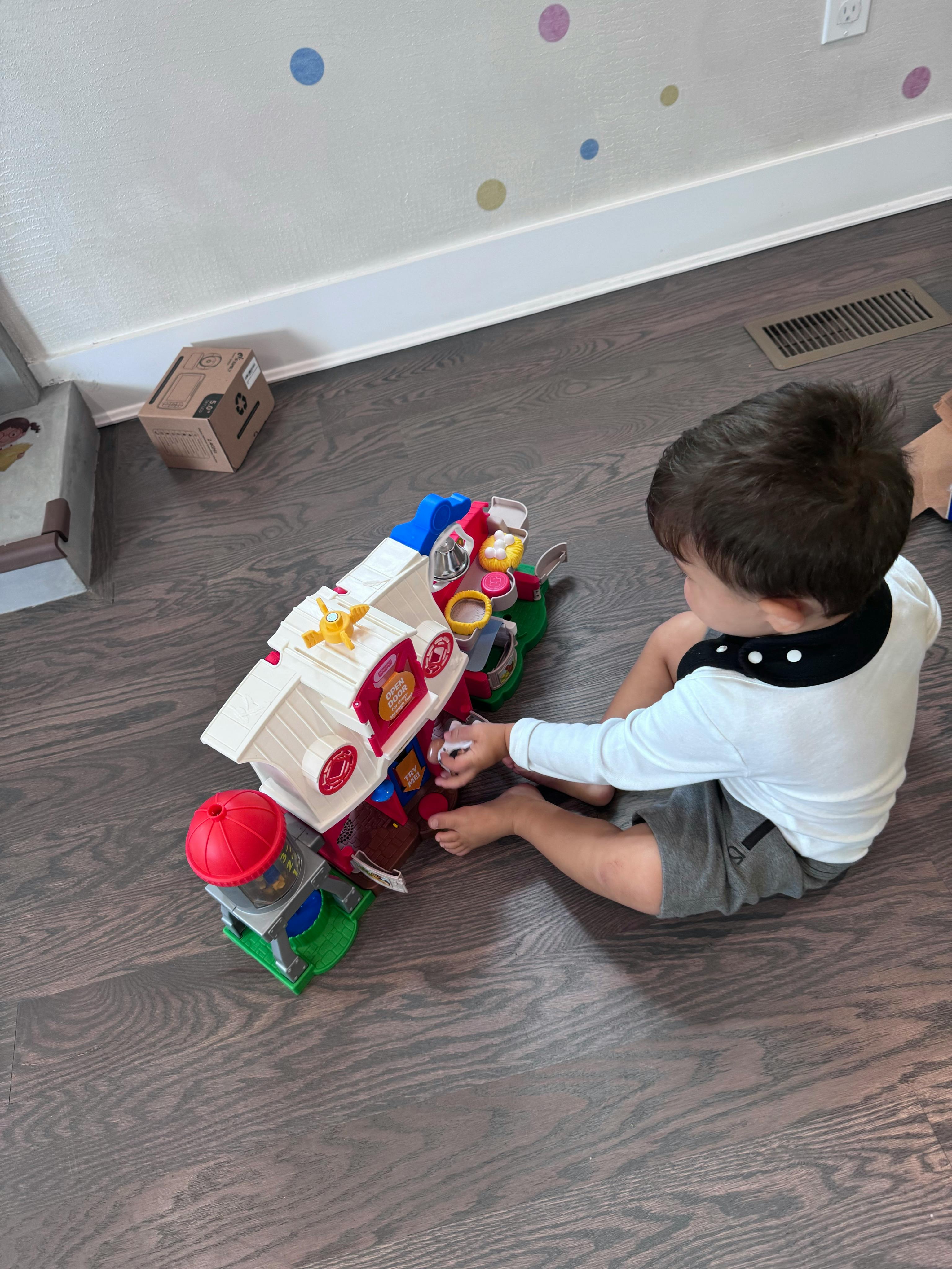 Child sitting on floor playing with a toy