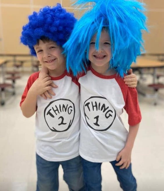 Two children in blue wigs and Thing 1 and Thing 2 shirts