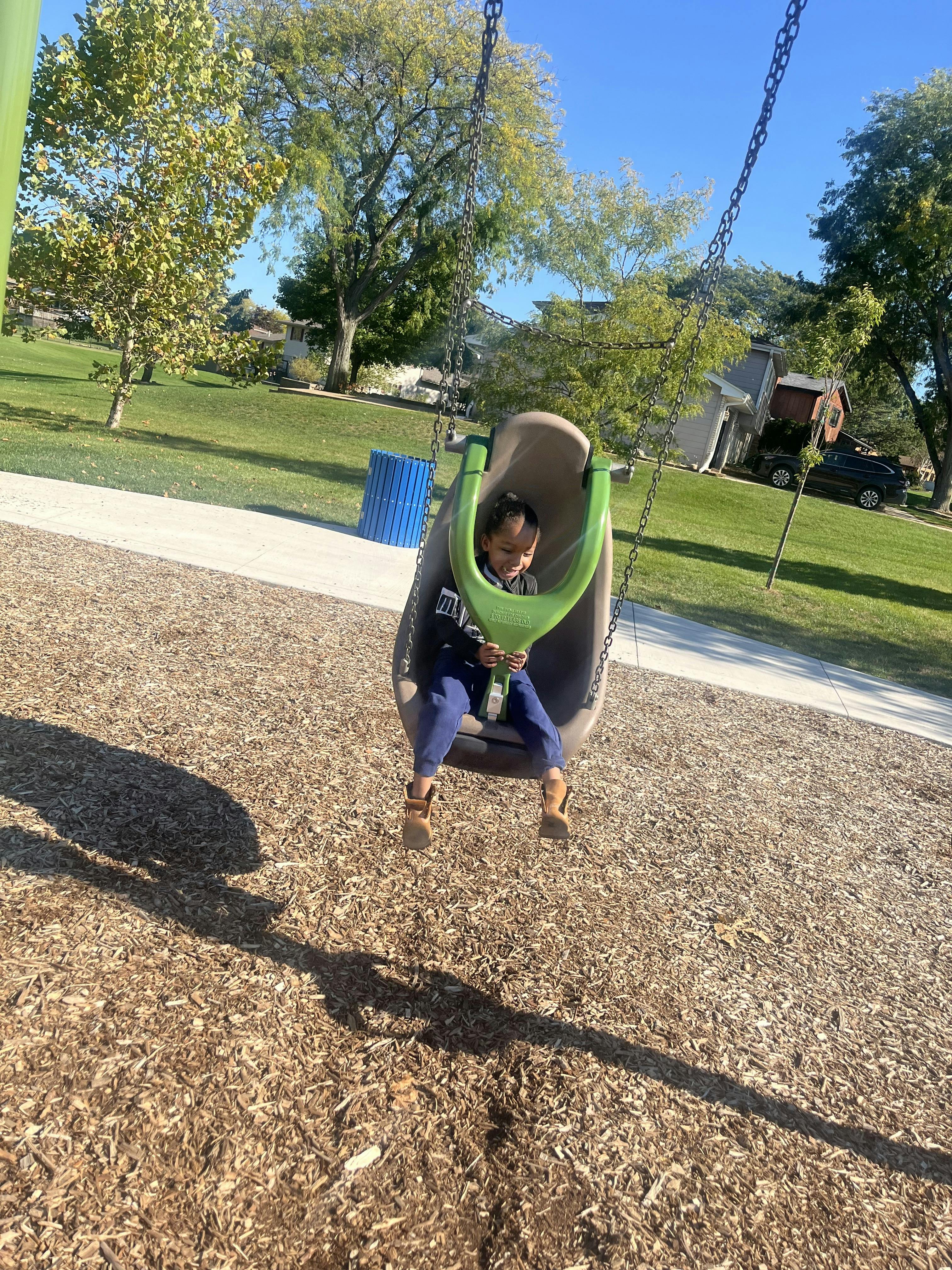 Child in a swing at a playground