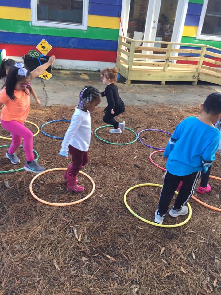 Children playing with hula hoops outdoors