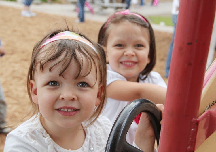 Two children on playground equipment