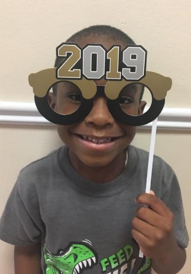 Child wearing 2019 novelty glasses