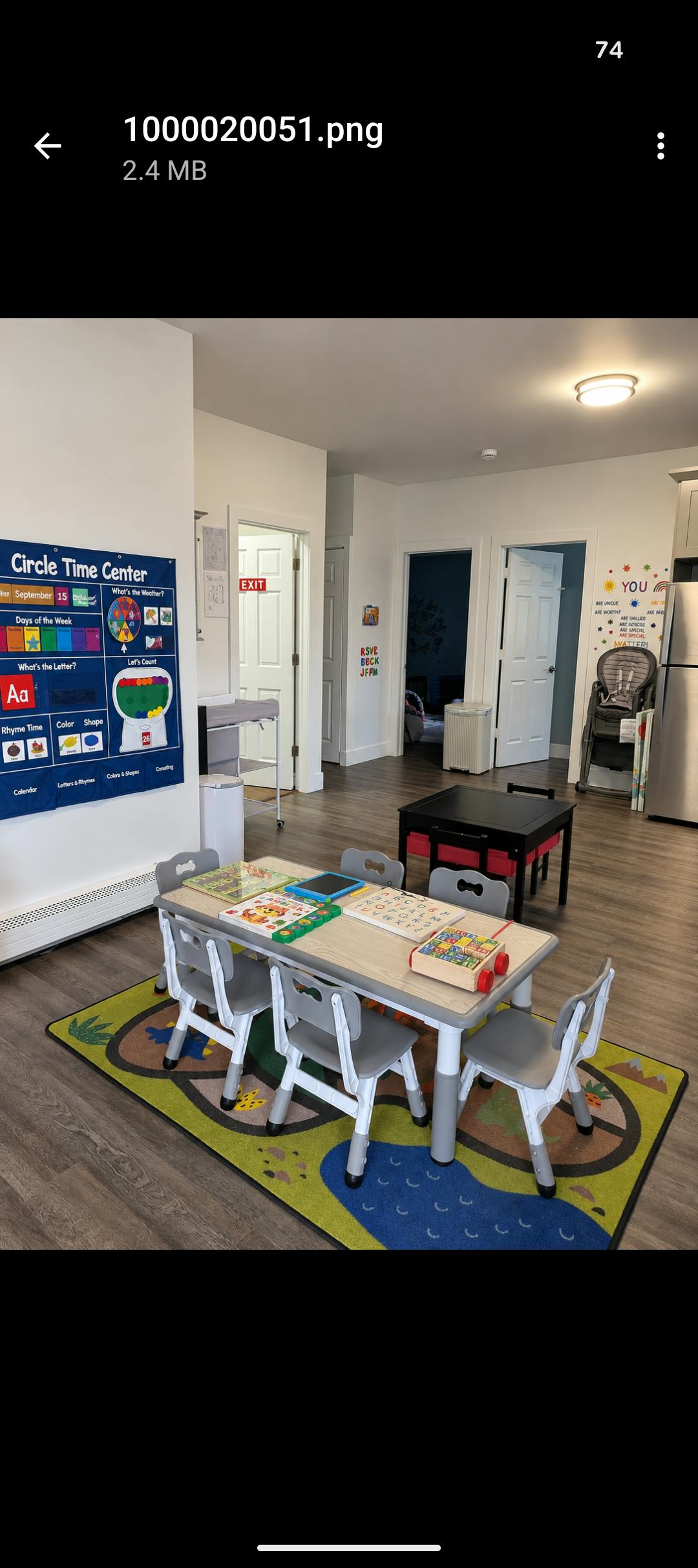 Childcare room with table and chairs on a play mat